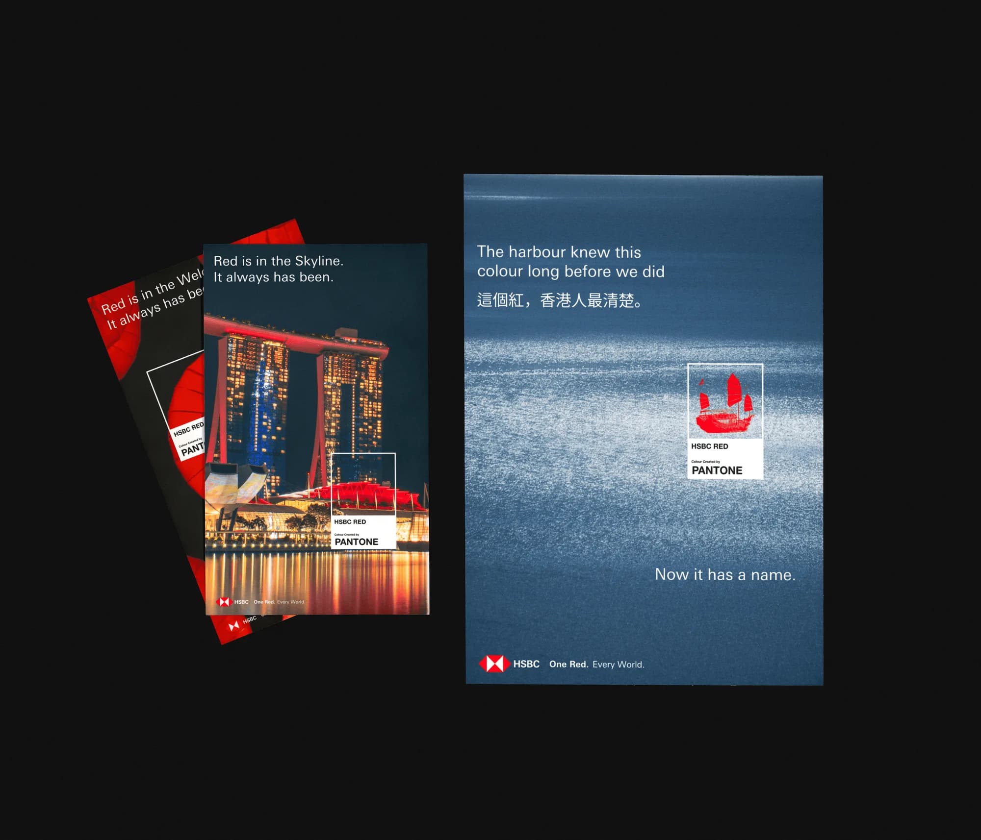 Three HSBC One Red. Every World. posters on black: Red is in the Skyline over Marina Bay Sands, and a red junk boat on the harbour, with HSBC RED Pantone cards