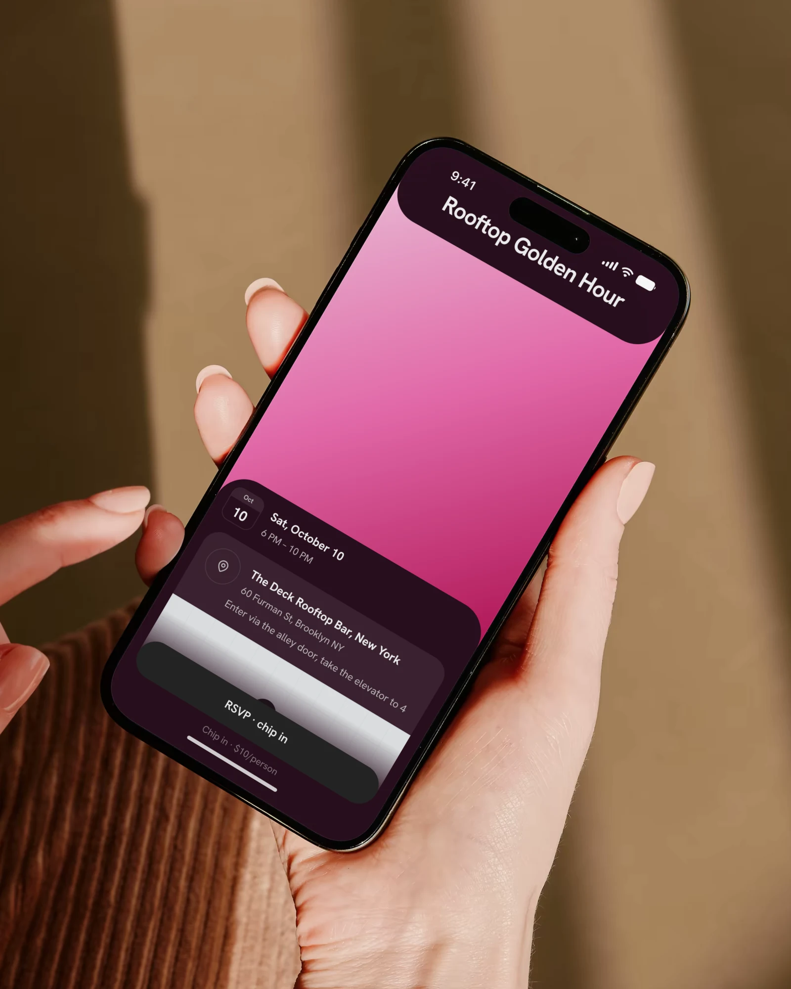 Two hands holding an iPhone, a thumb reaching to tap: the Rooftop Golden Hour event page as guests see it