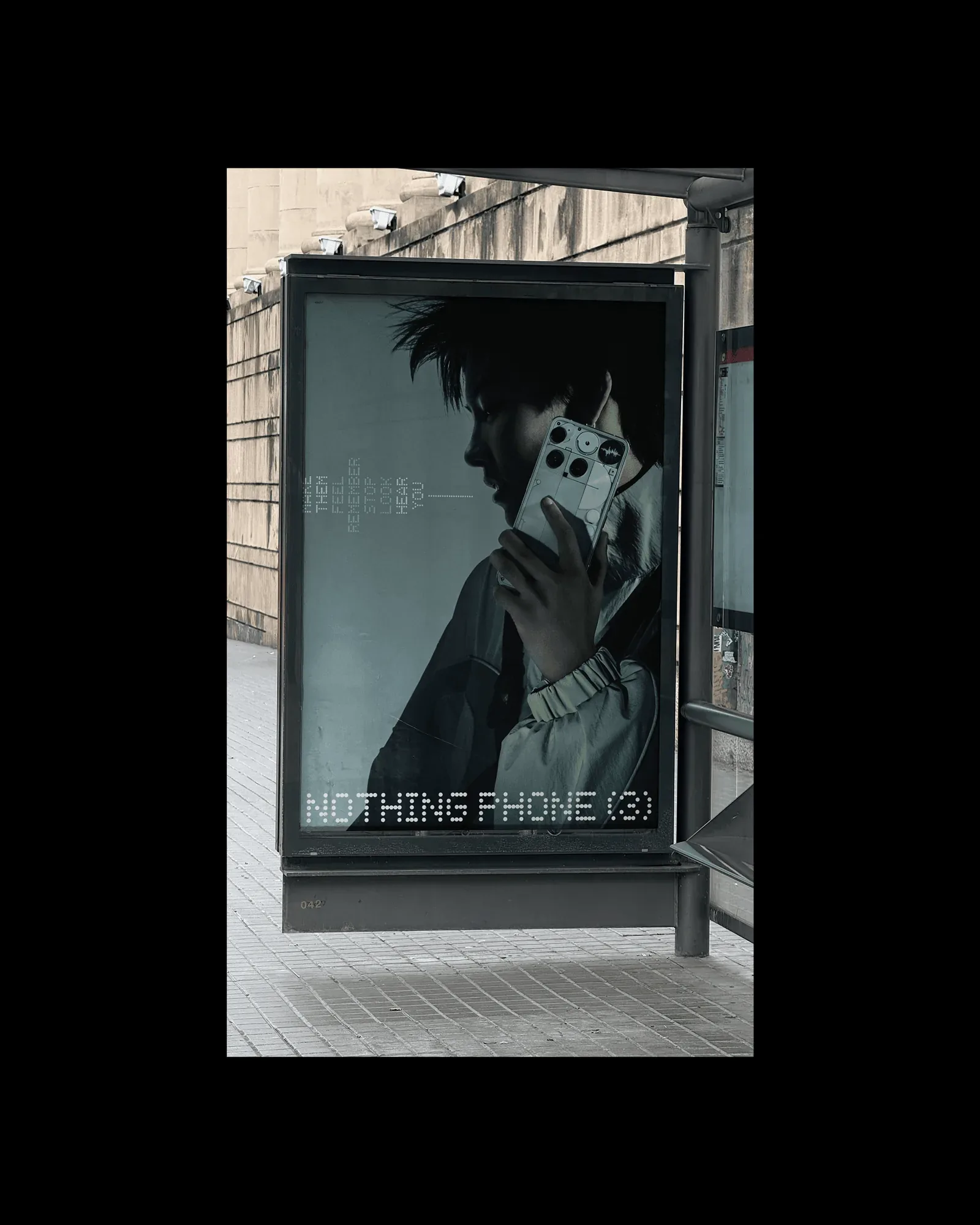 A bus-shelter poster of a person holding a white Nothing phone to their ear, NOTHING PHONE (3) in dot type