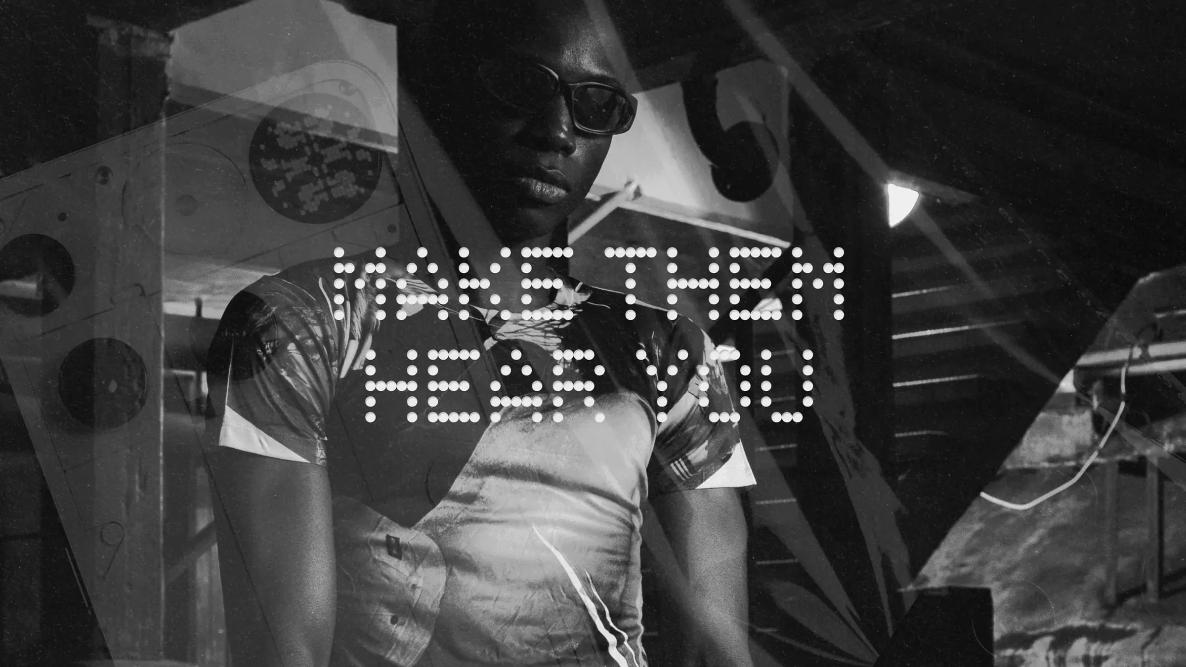 Make Them Hear You: a grainy black-and-white portrait of a man in sunglasses layered over speaker hardware, the line set in Nothing's white dot-matrix type
