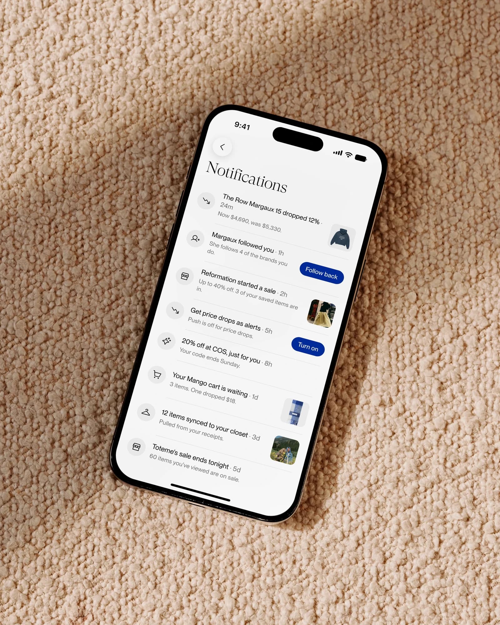The notification feed on a phone lying on a boucle throw: price drops, a follow-back, sales and cart reminders, each row with either an image or a button