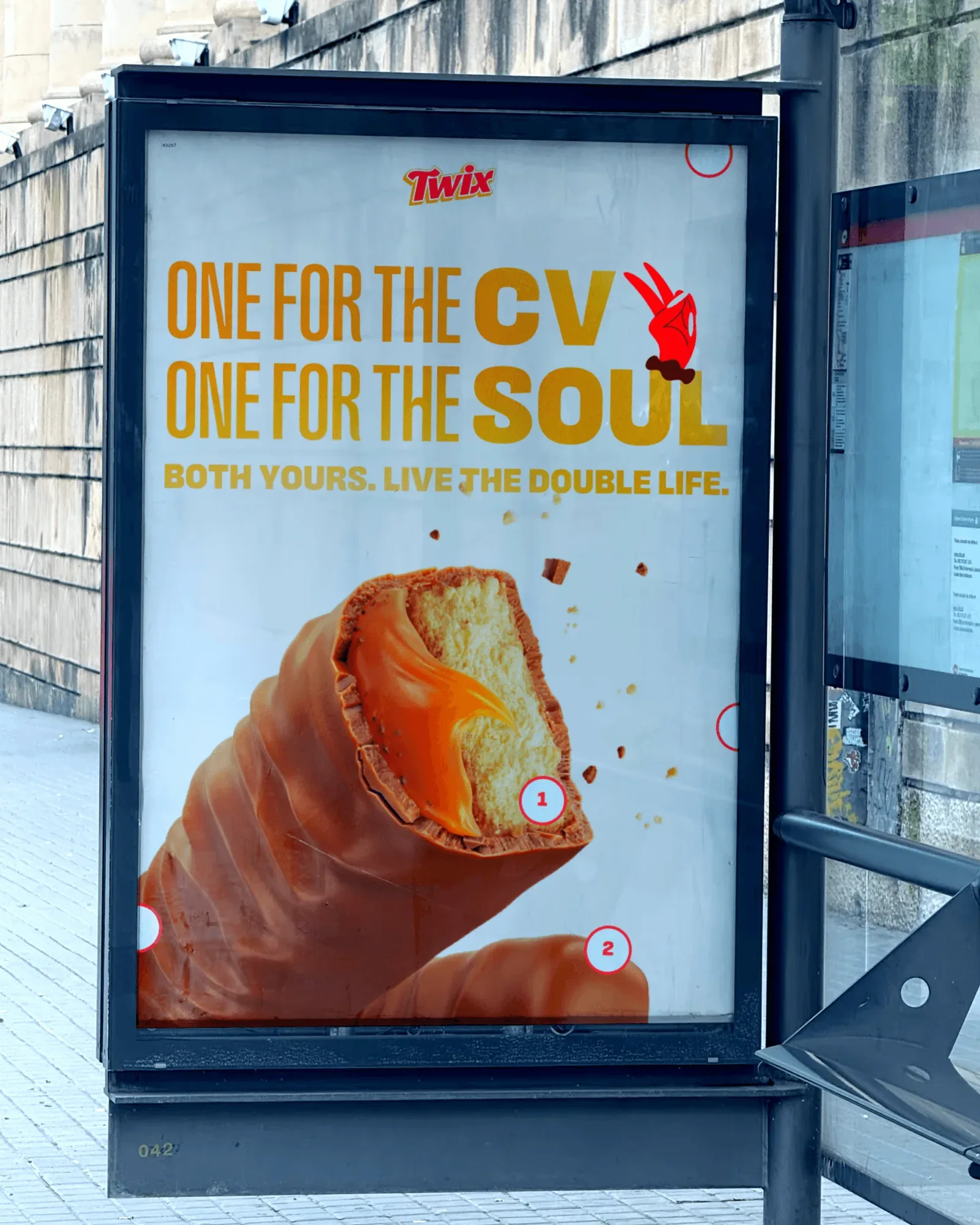 A bus-shelter poster: ONE FOR THE CV, ONE FOR THE SOUL, BOTH YOURS. LIVE THE DOUBLE LIFE., over a bitten Twix bar