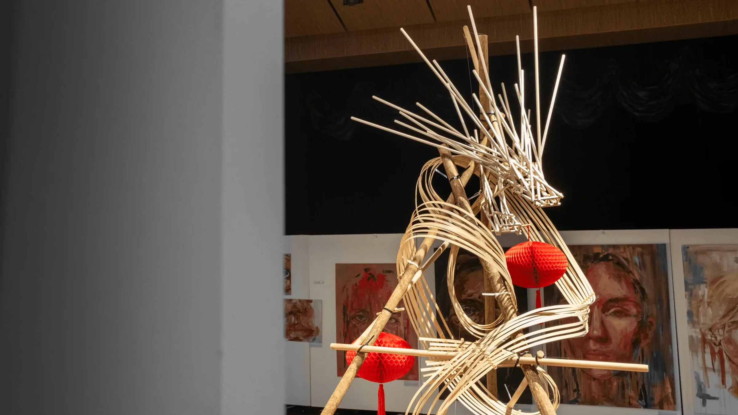 魚躍龍門 Metamorphosis: a bamboo dragon mid-leap through red paper lanterns, in the exhibition hall