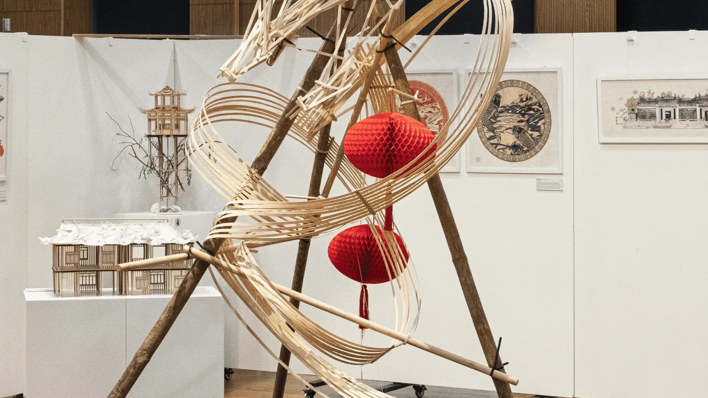 魚躍龍門 Metamorphosis, March 2025, bamboo and balsa, 150 × 150 × 230 cm: the dragon on its black plinth with red lanterns