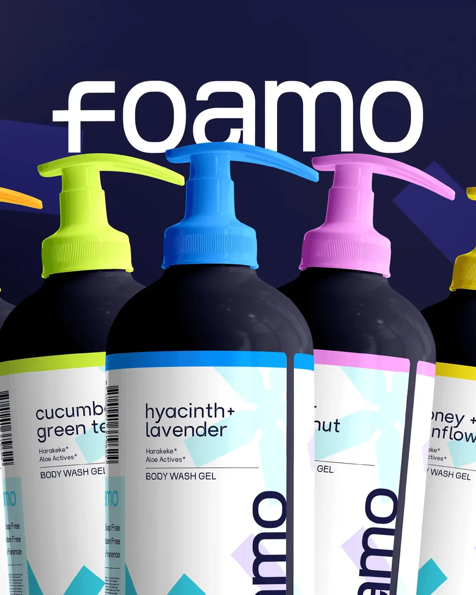 The white foamo wordmark above five dark body wash bottles with orange, lime, blue, pink and yellow pumps, on deep indigo