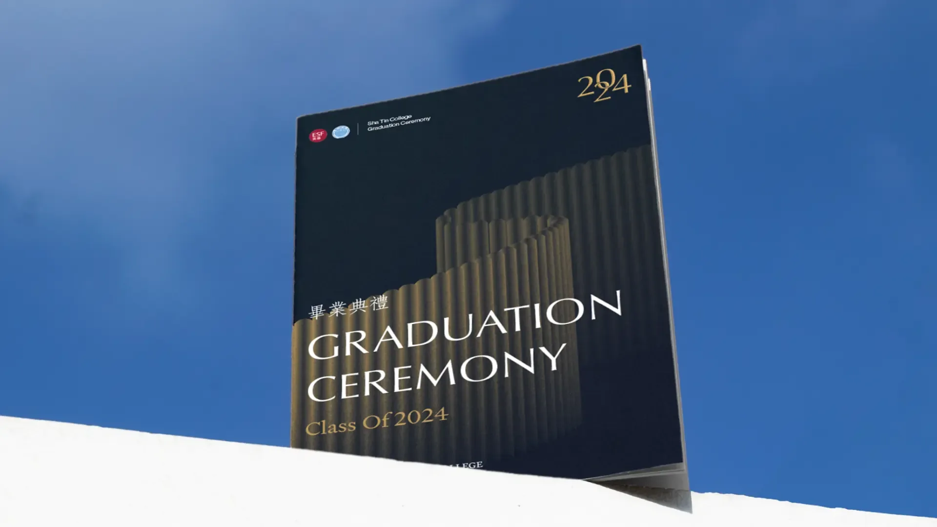 The Graduation Ceremony, Class Of 2024 programme standing against a blue sky