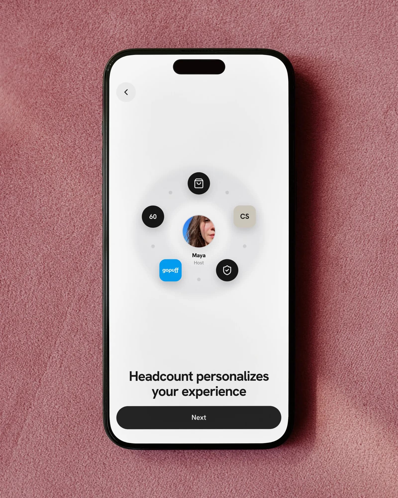 An iPhone on pink velvet: the host in the middle of an orbit of what the headcount decides, titled Headcount personalizes your experience